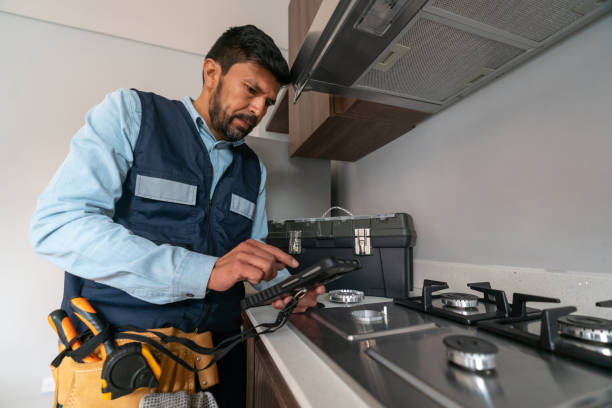 Supervisor making a gas inspection at a house and checking for leaks in the stove by Kitchens by RUPP